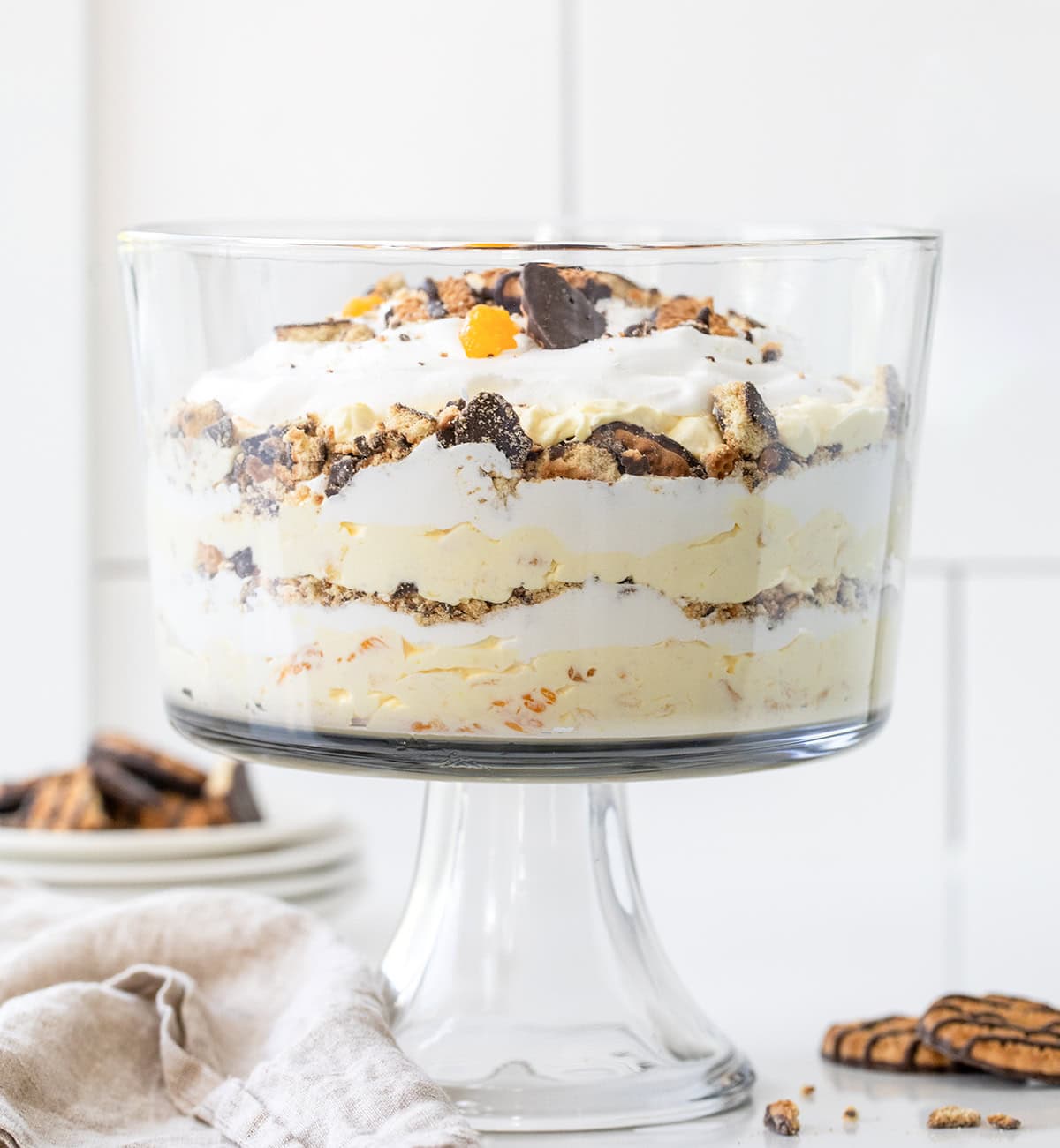 Cookie Salad Trifle in trifle dish on a white counter. 
