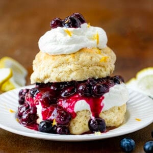 Lemon Blueberry Shortcake on a white plate on a wooden table.