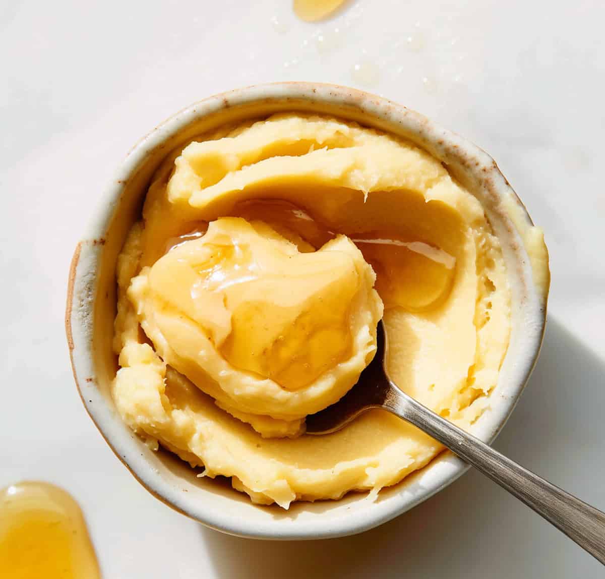 Bowl of honey butter with a spoon.