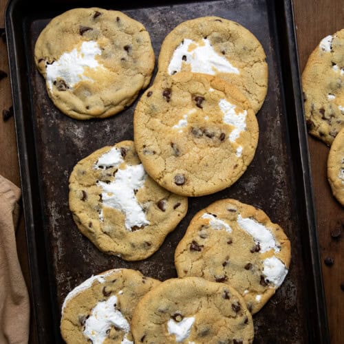 Marshmallow Chocolate Chip Cookies on a cookie sheet on a wooden table from overhead.