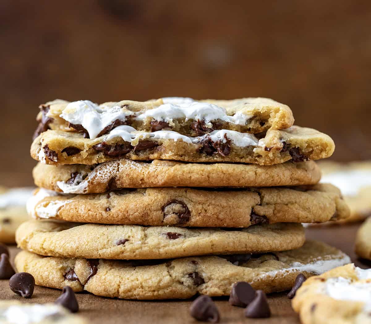 Stack of Marshmallow Chocolate Chip Cookies with the top cookie broken in half showing chewy texture.