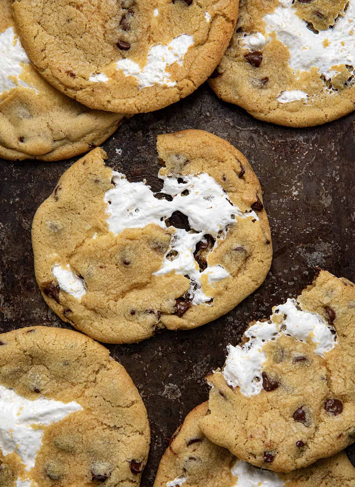 Marshmallow Chocolate Chip Cookies with center cookie partially pulled in half showing ooey gooey marshmallow. 