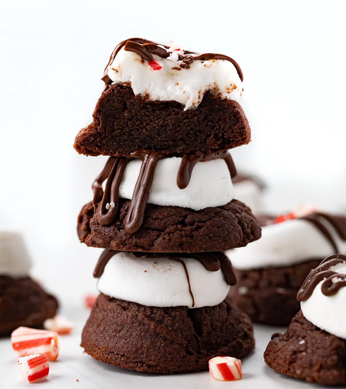 Stack of Peppermint Hot Chocolate Cookies with top cookie cut in half showing inside texture.