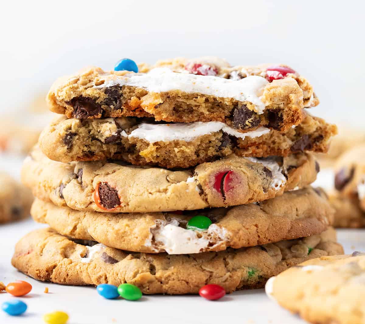 Stack of Marshmallow Monster Cookies with top cookie broken in half showing inside texture.