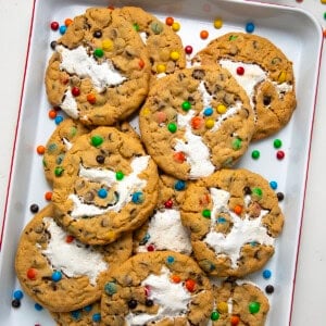 Marshmallow Monster Cookies in a pan on a white table from overhead.