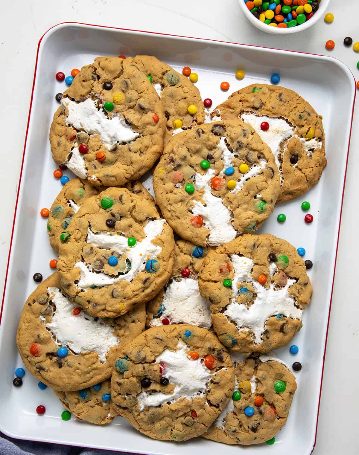 Marshmallow Monster Cookies in a pan on a white table from overhead. 