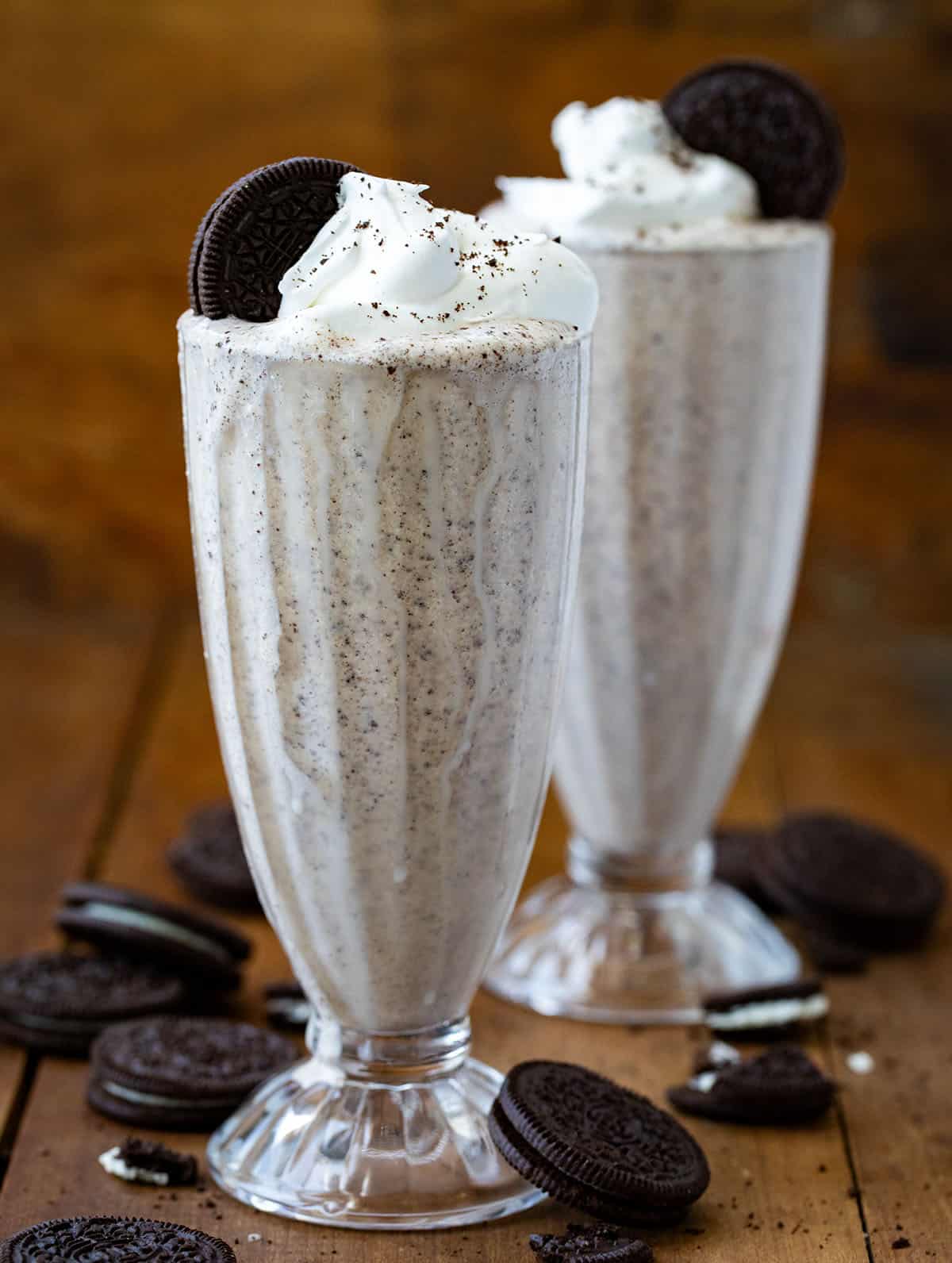 Two Oreo Milkshakes on a wooden table. 