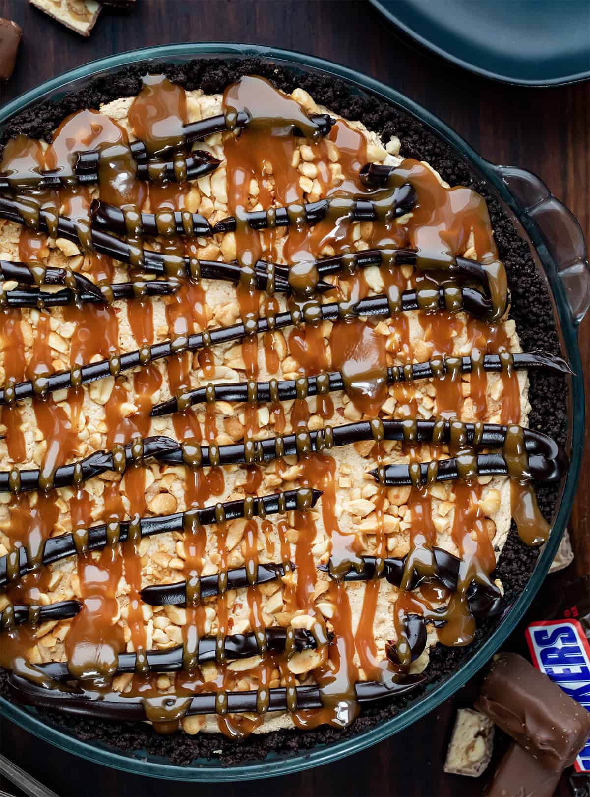 Close up of a brownie pie covered in nougat and fudge and caramel. 