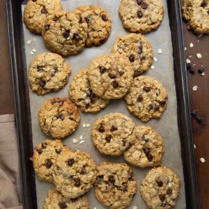 Brown Butter Oatmeal Chocolate Chip Cookies on a tray on a wooden table from overhead.