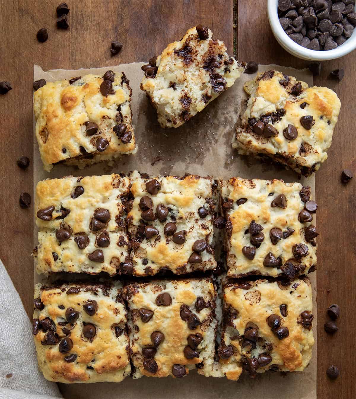 Chocolate Chip Butter Swim Biscuits cut into pieces on a wooden table from overhead.