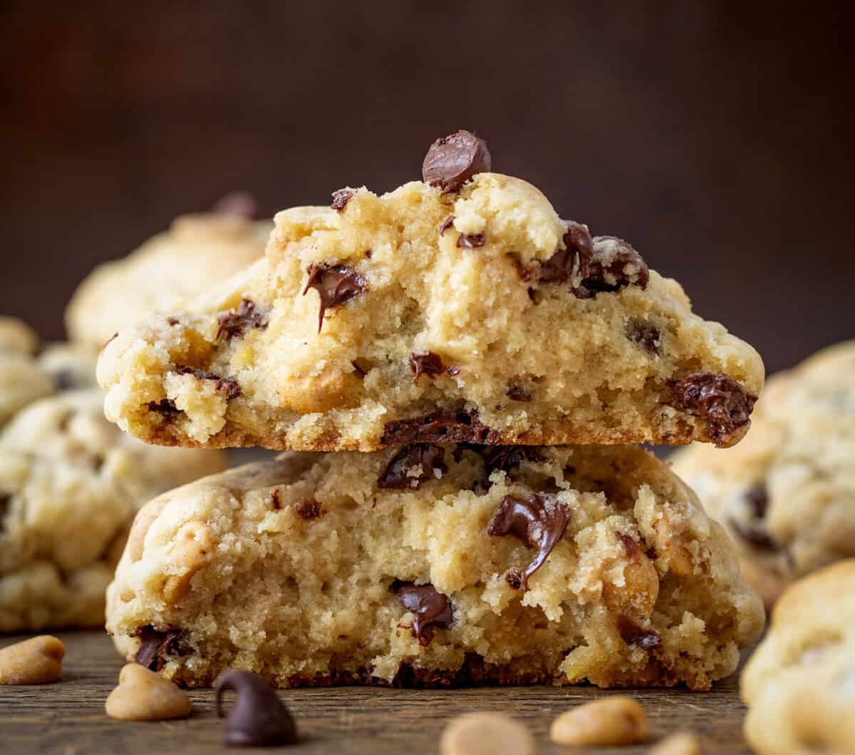 Thick and Chewy Peanut Butter Chocolate Chip Cookies that have been halved and show inside texture.