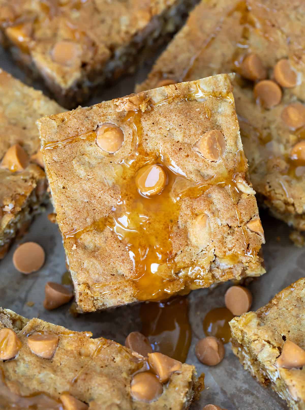 Close up of a Oatmeal Butterscotch Bar with butterscotch sauce on it.