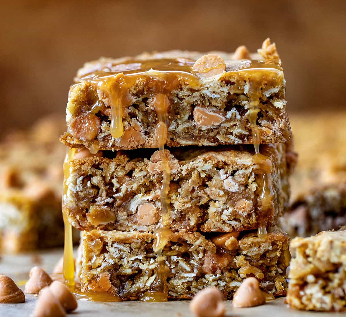 Stack of Oatmeal Butterscotch Bars on a wooden table straight on and close up.