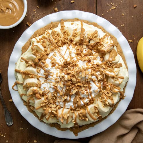 Peanut Butter Banana Cream Pie on a wooden table from overhead.