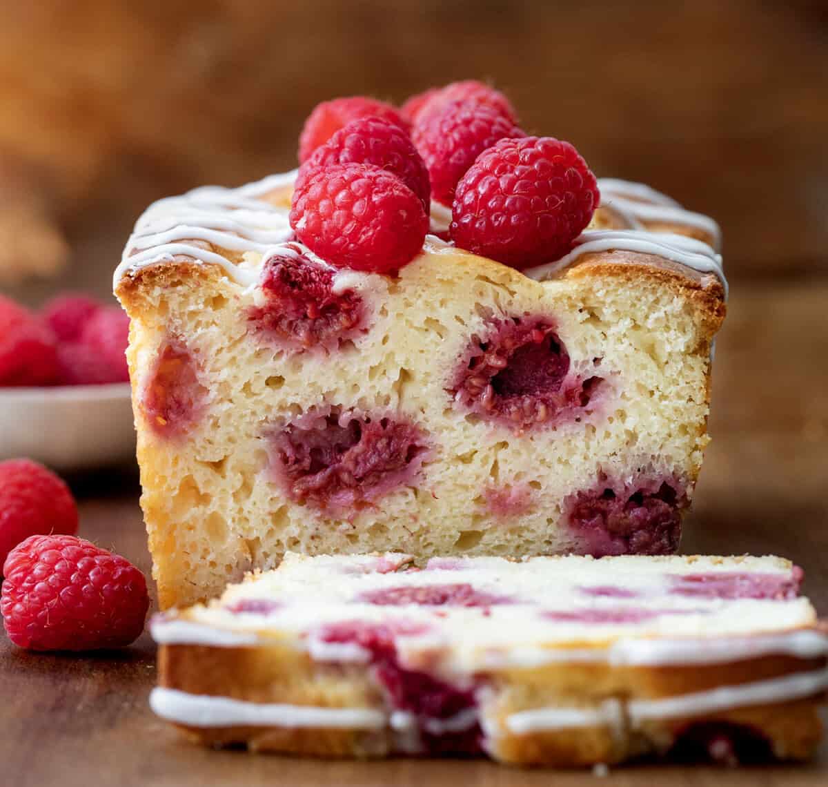 Loaf of Raspberry Bread that has a piece cut off showing the inside texture.