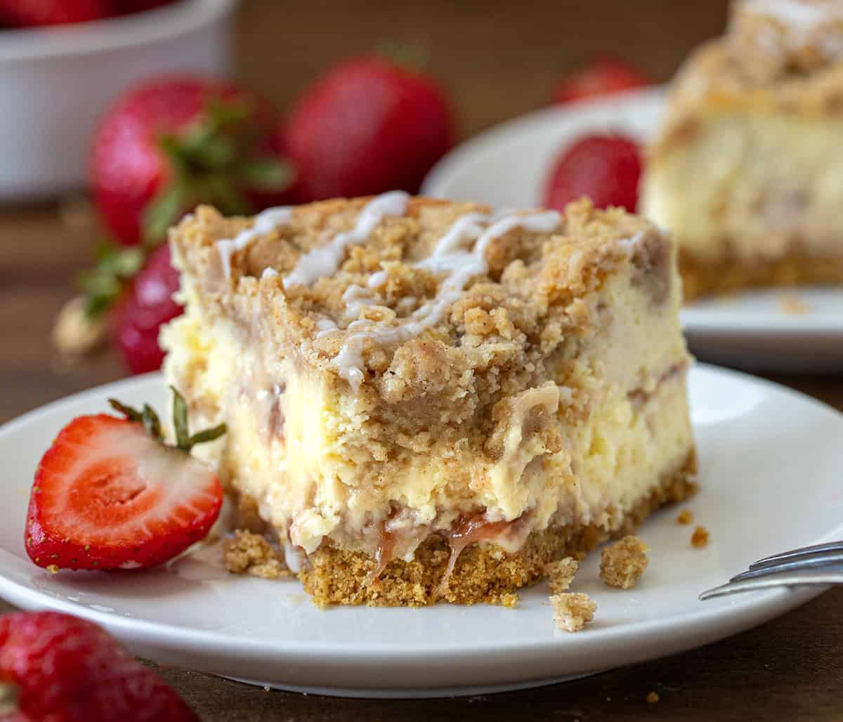 Plate of Strawberry Crumble Cheesecake with a bite taken out of it.