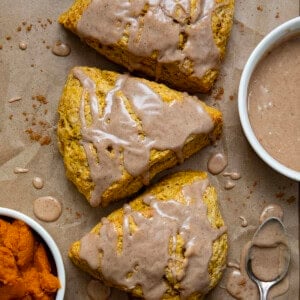 Pumpkin Scones on a wooden table on parchment paper from overhead.