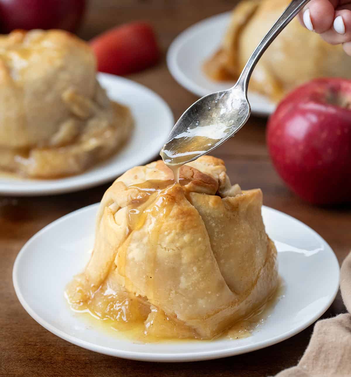 Spooning glaze over Apple Dumplings.