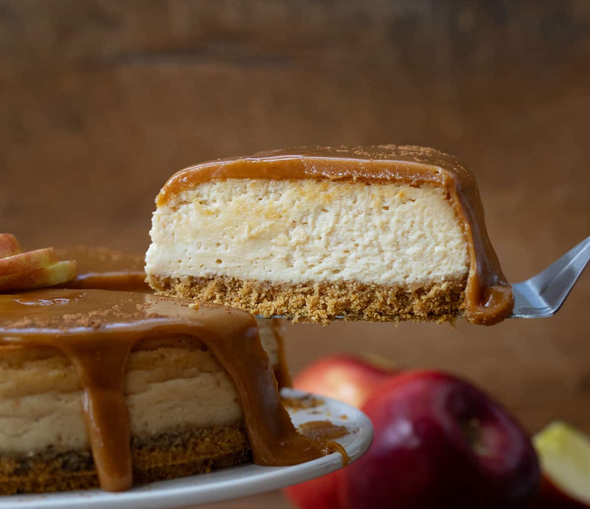 Holding a piece of Apple Cider Cheesecake after removing it from the cake stand.