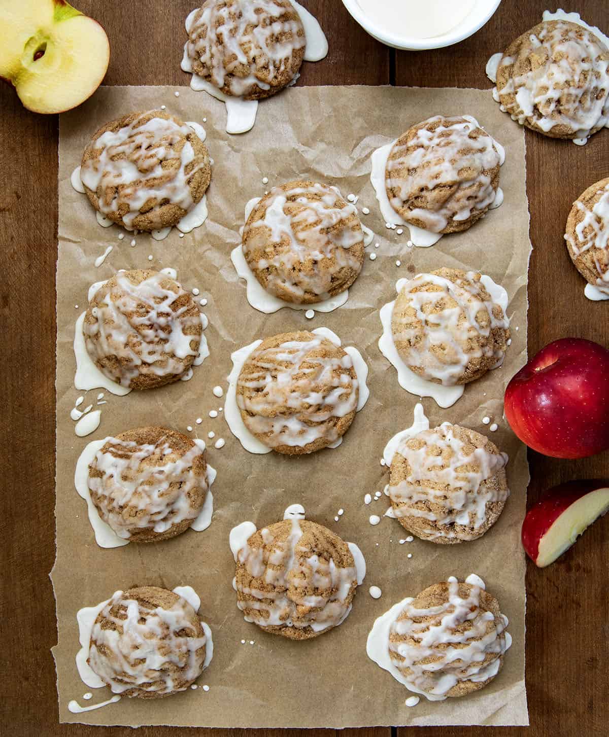 Apple Cider Cookies on a piece of parchment paper on a wooden table from overhead.