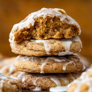 Stack of Apple Cider Cookies with top cookie halved showing tender crumb of cookie.