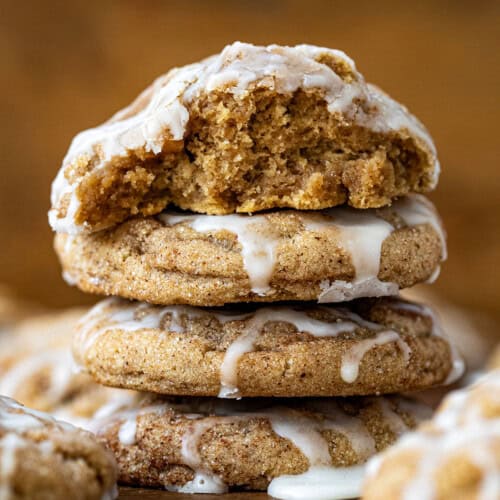 Stack of Apple Cider Cookies with top cookie halved showing tender crumb of cookie.