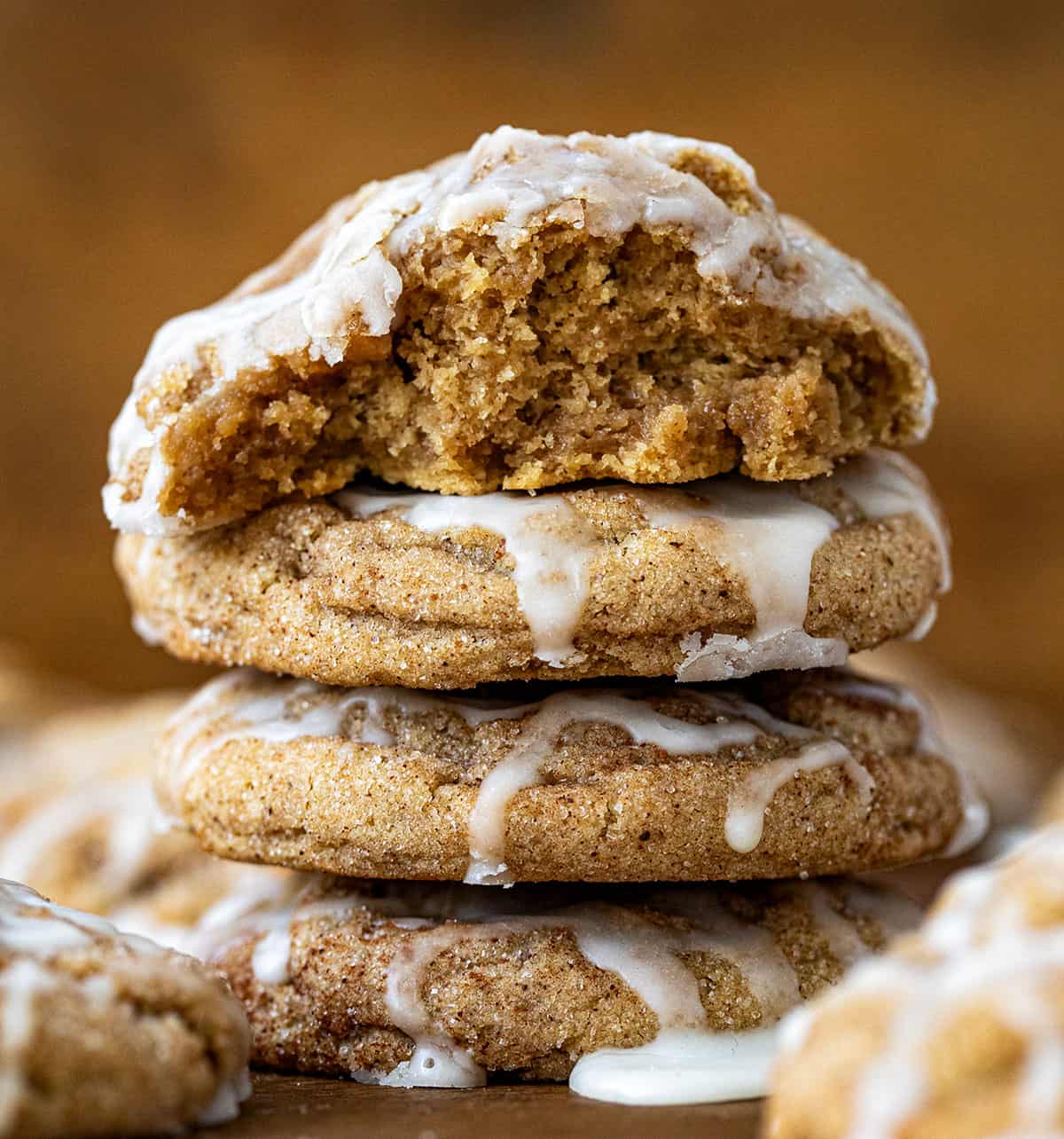 Stack of Apple Cider Cookies with top cookie halved showing tender crumb of cookie.