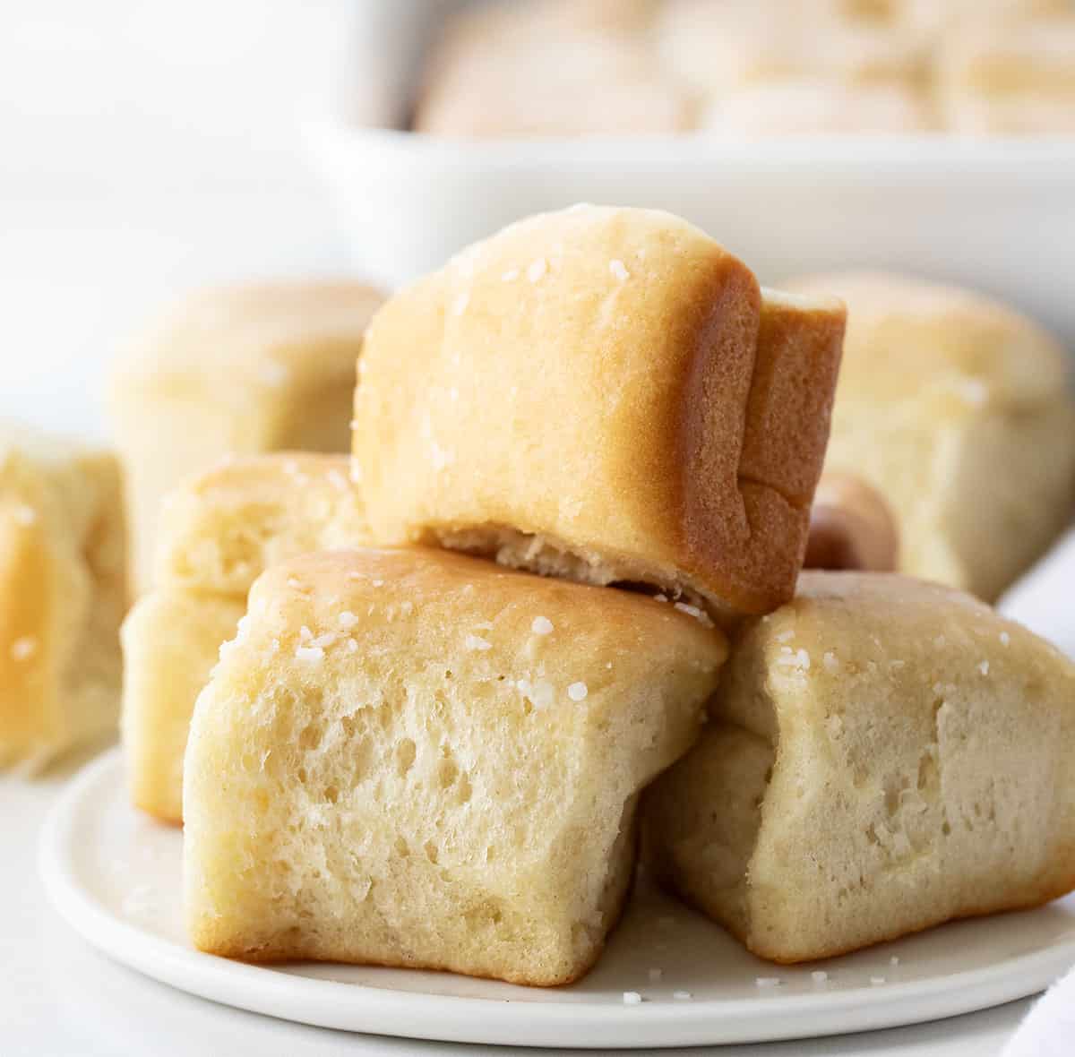 White plate with Parker House Rolls on it.