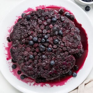 Baked Cream Cheese Blueberry Bombs on a white platter on a white table from overhead.