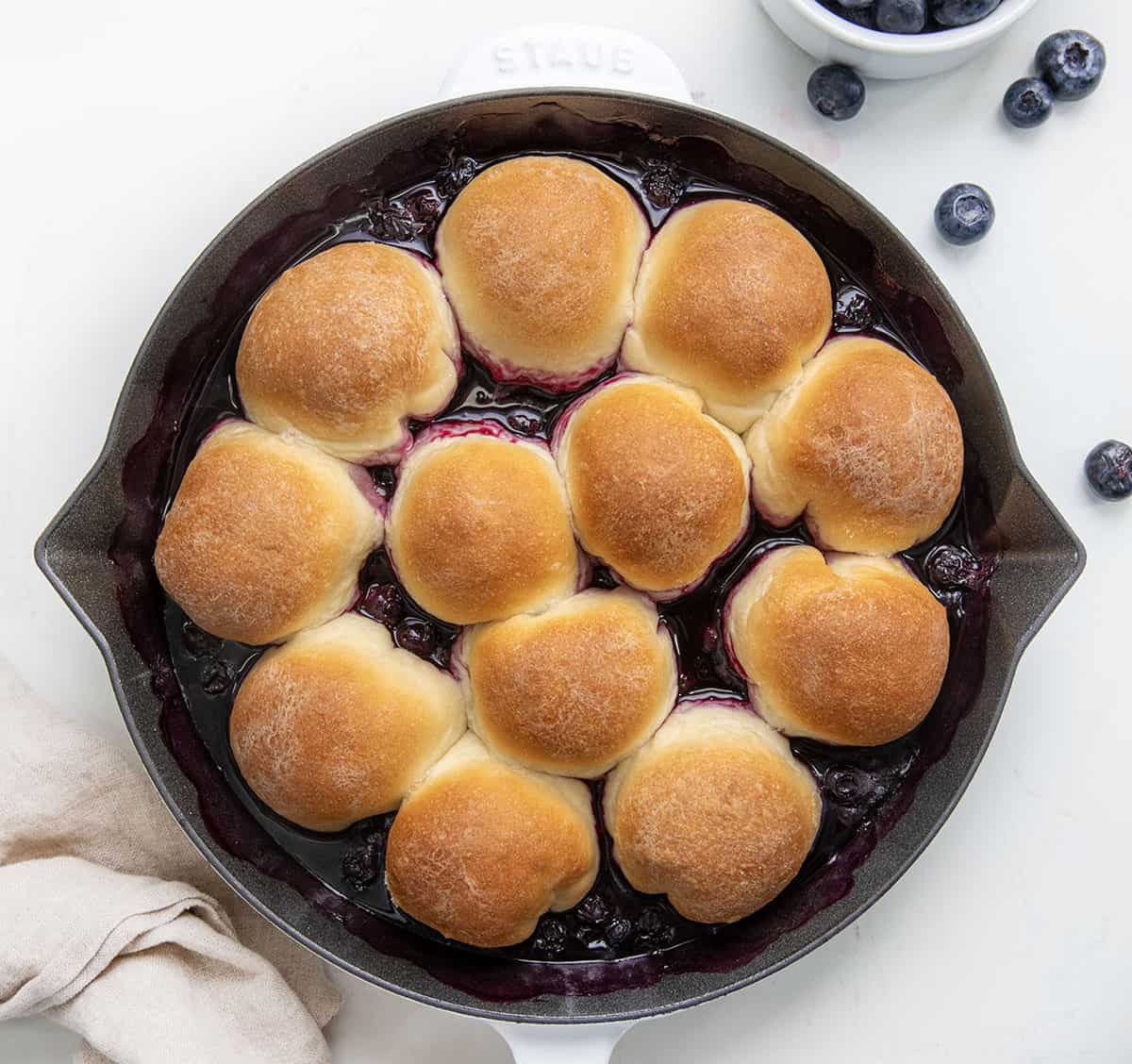 Baked Cream Cheese Blueberry Bombs directly out of the oven right before they get flipped onto a plate.