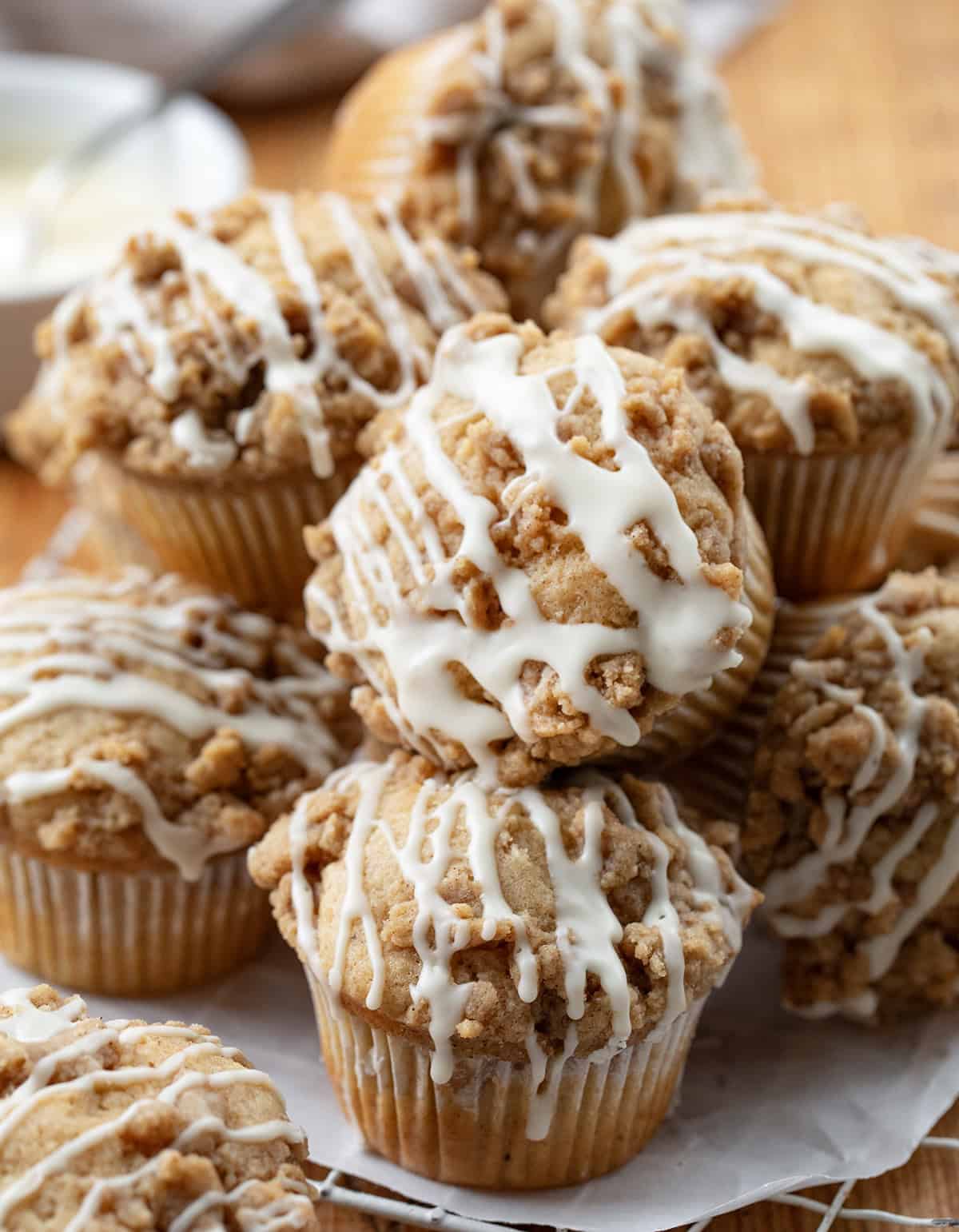 Many Eggnog Muffins on a table stacked.