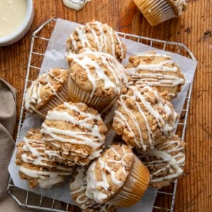 Eggnog Muffins on a cooling rack on a wooden table from overhead.