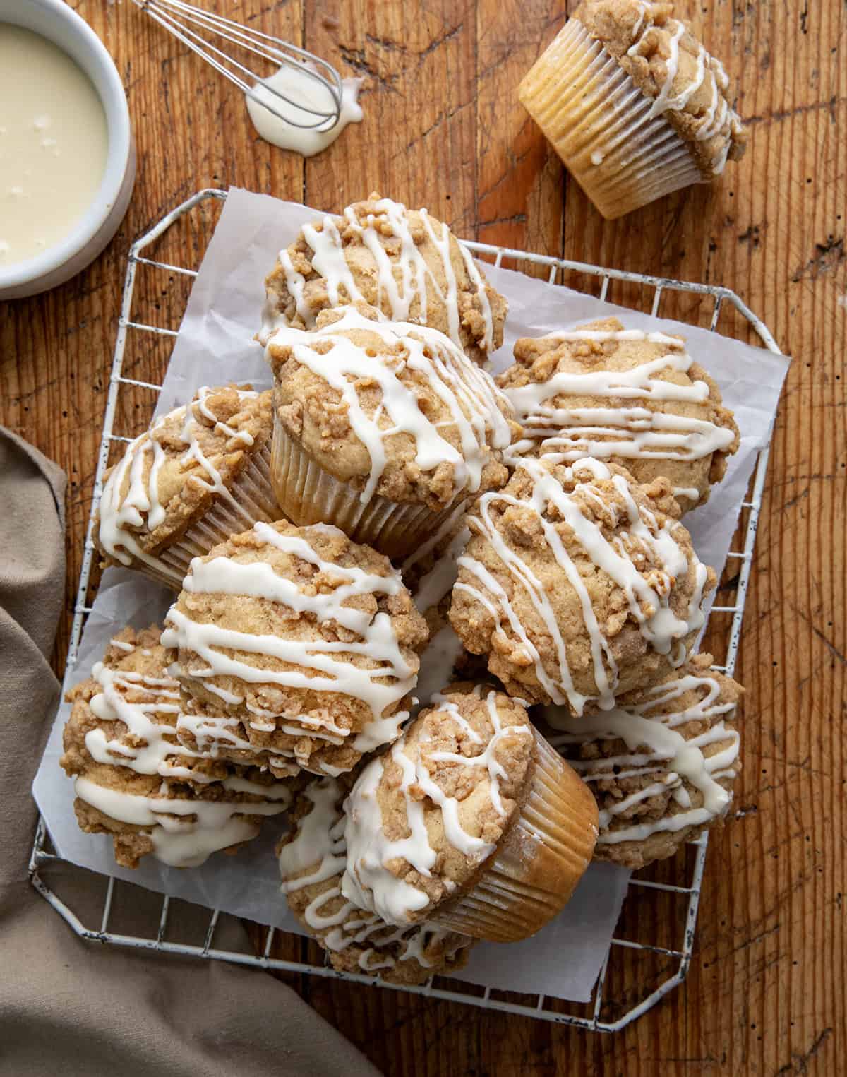 Eggnog Muffins on a cooling rack on a wooden table from overhead.