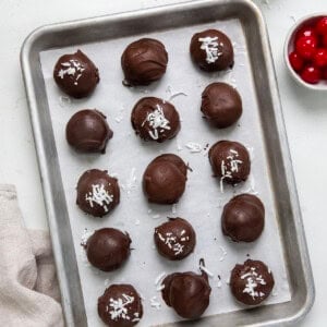 Martha Washington Candy on a tray on a white table with cherries.