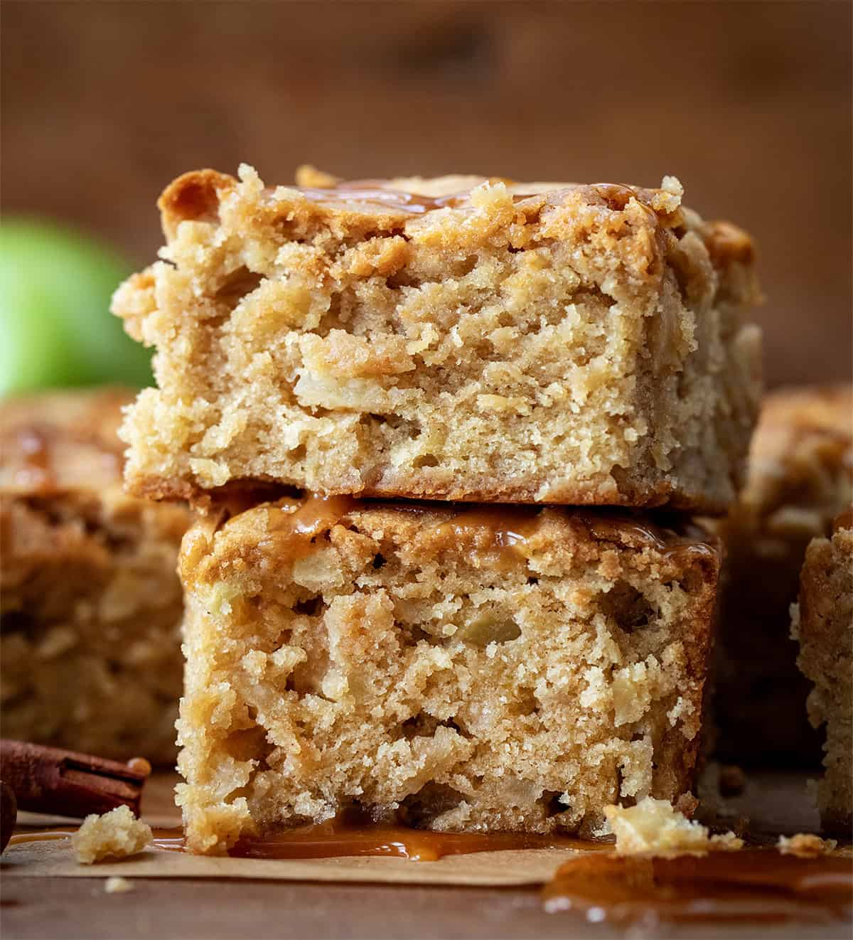 Stack of pieces of Caramel Apple Snack Cake on a wooden table.