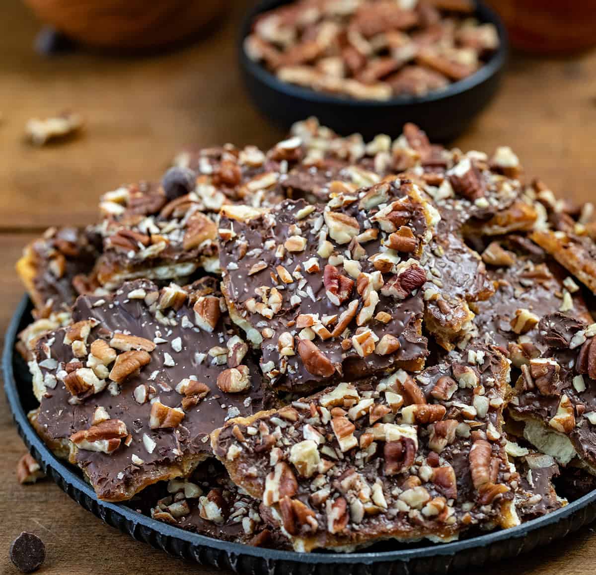 Maple Pecan Christmas Crack on a platter on a wooden table.