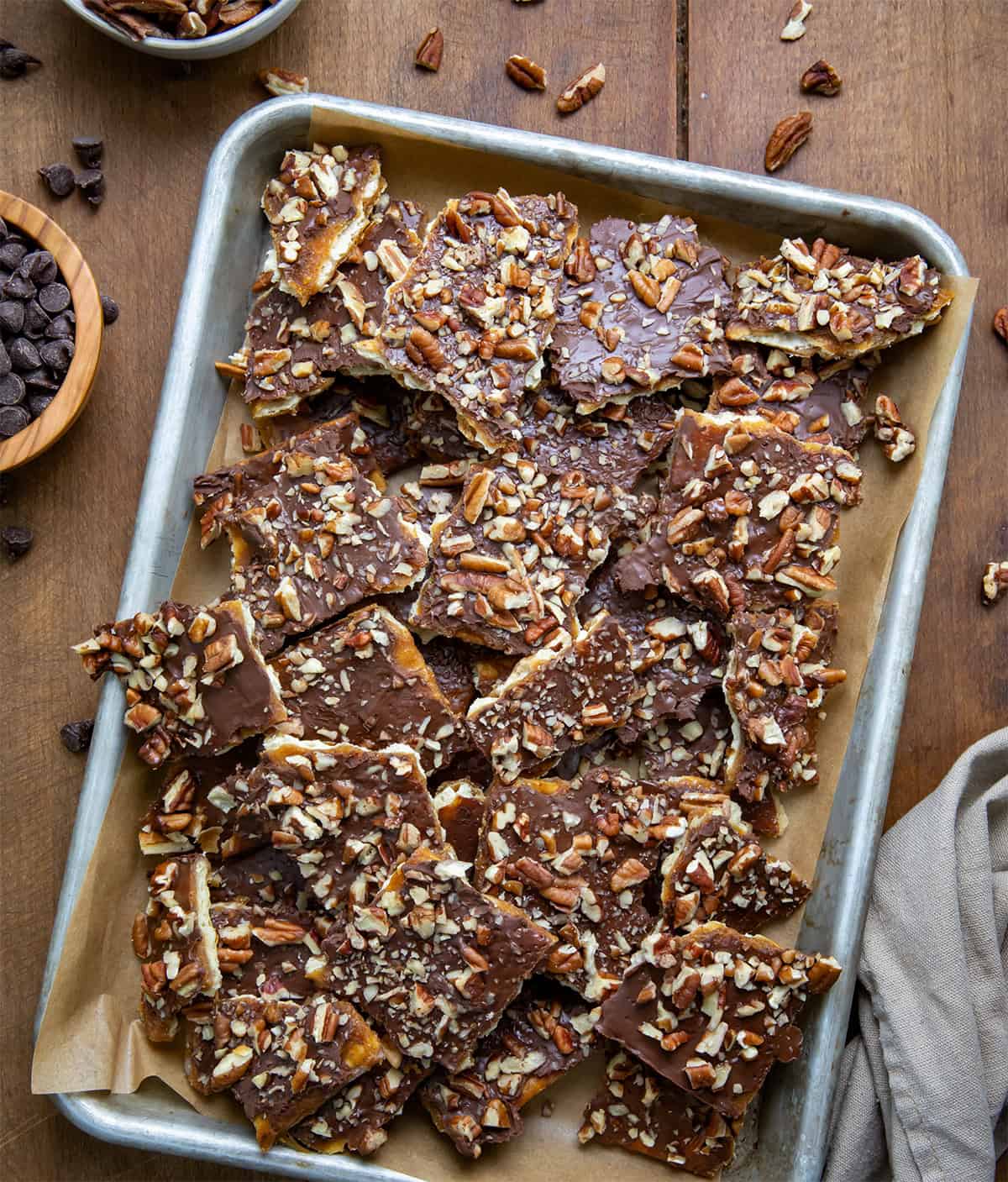 Pan of Maple Pecan Christmas Crack on a wooden table from overhead.