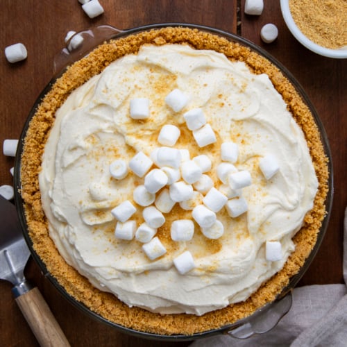 Whole Marshmallow Cream Cheesecake on a wooden table from overhead.