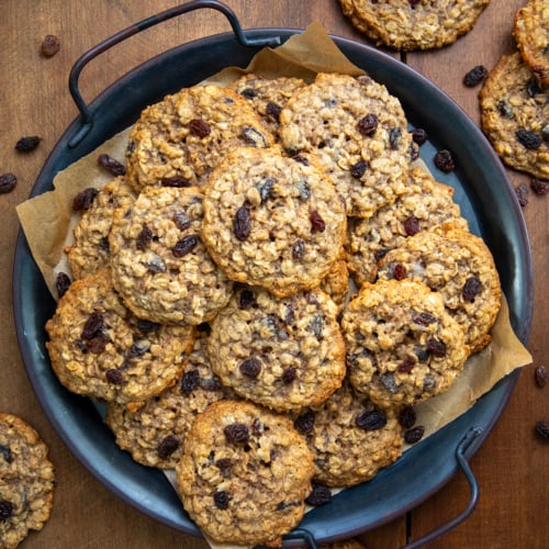 Tray of Oatmeal Raisin Cookies on a wooden table from overhead.