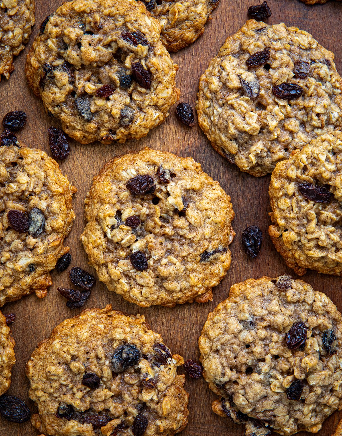 Close up of Oatmeal Raisin Cookies on a wooden table from overhead.