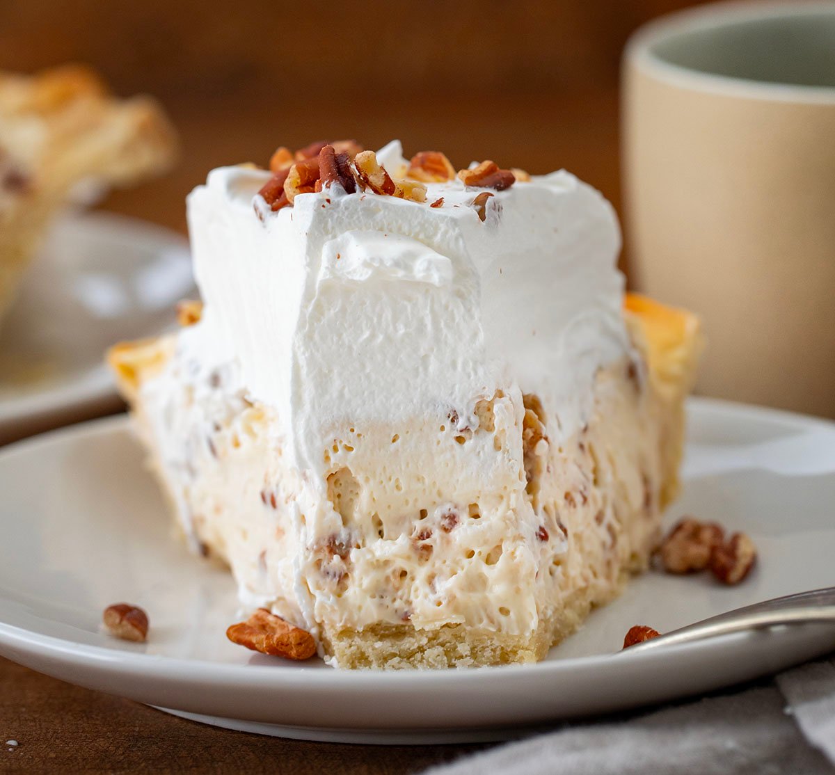 Piece of Pecan Cream Pie with a bite taken out of it.