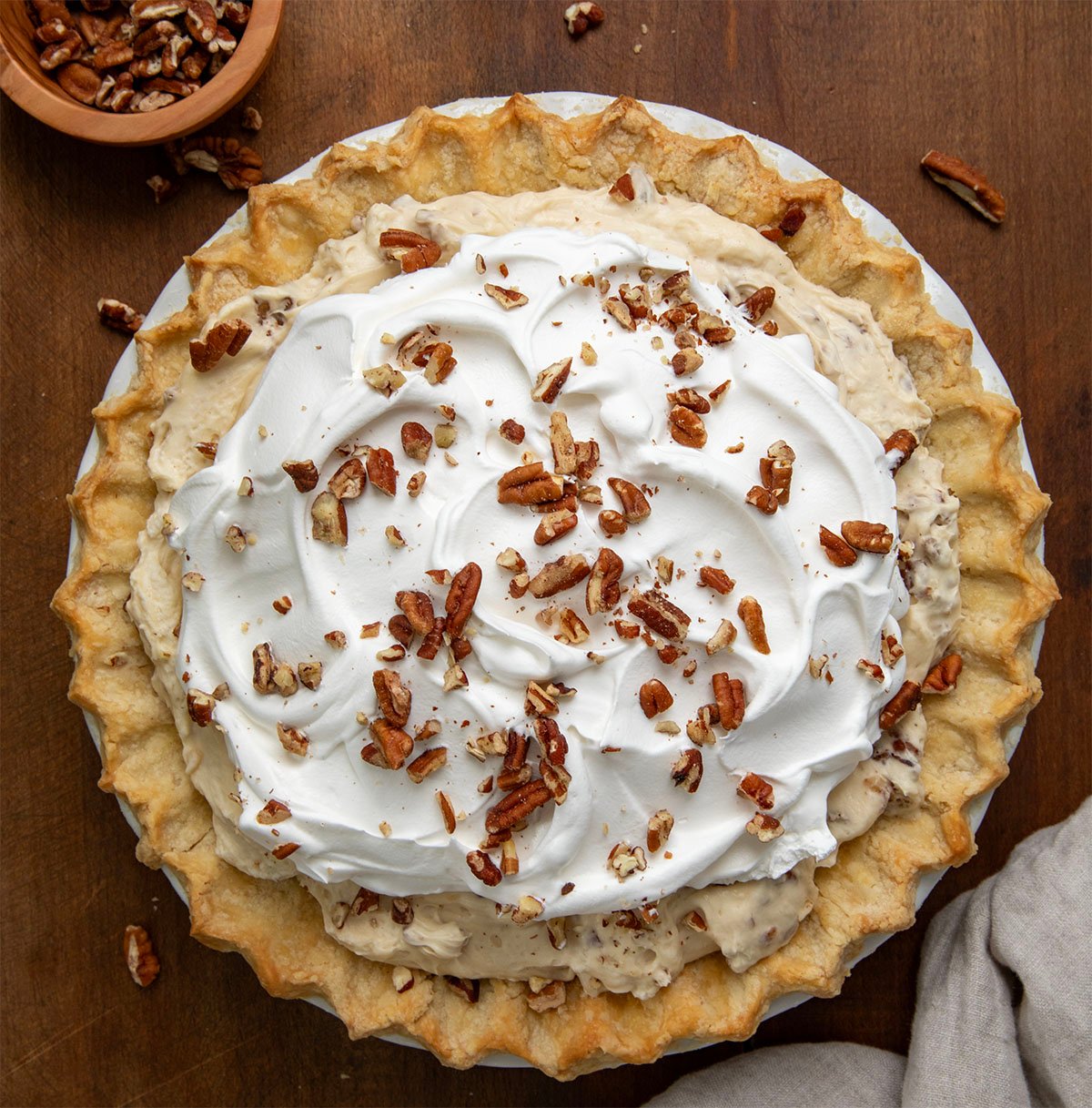 Looking down on a Pecan Cream Pie on a wooden table. 