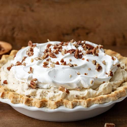 Whole Pecan Cream Pie on a wooden table.