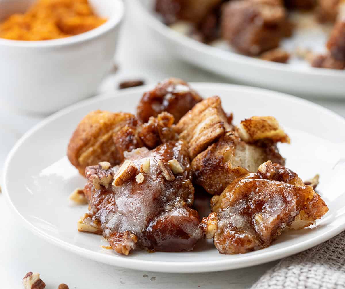 White plate with pieces of Pumpkin Monkey Bread on it.