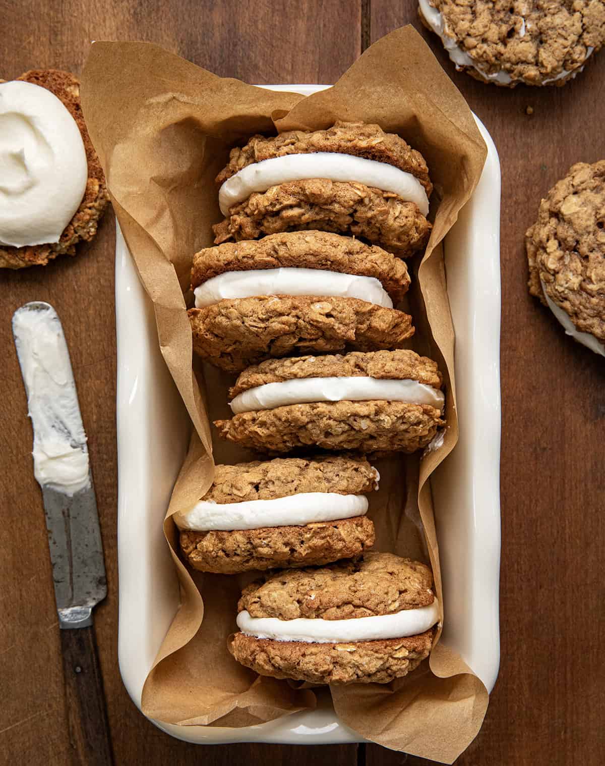 Pumpkin Oatmeal Cream Pies in a loaf pan on a wooden table from overhead.