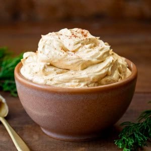 Bowl of Whipped Gingerbread Butter on a wooden table.