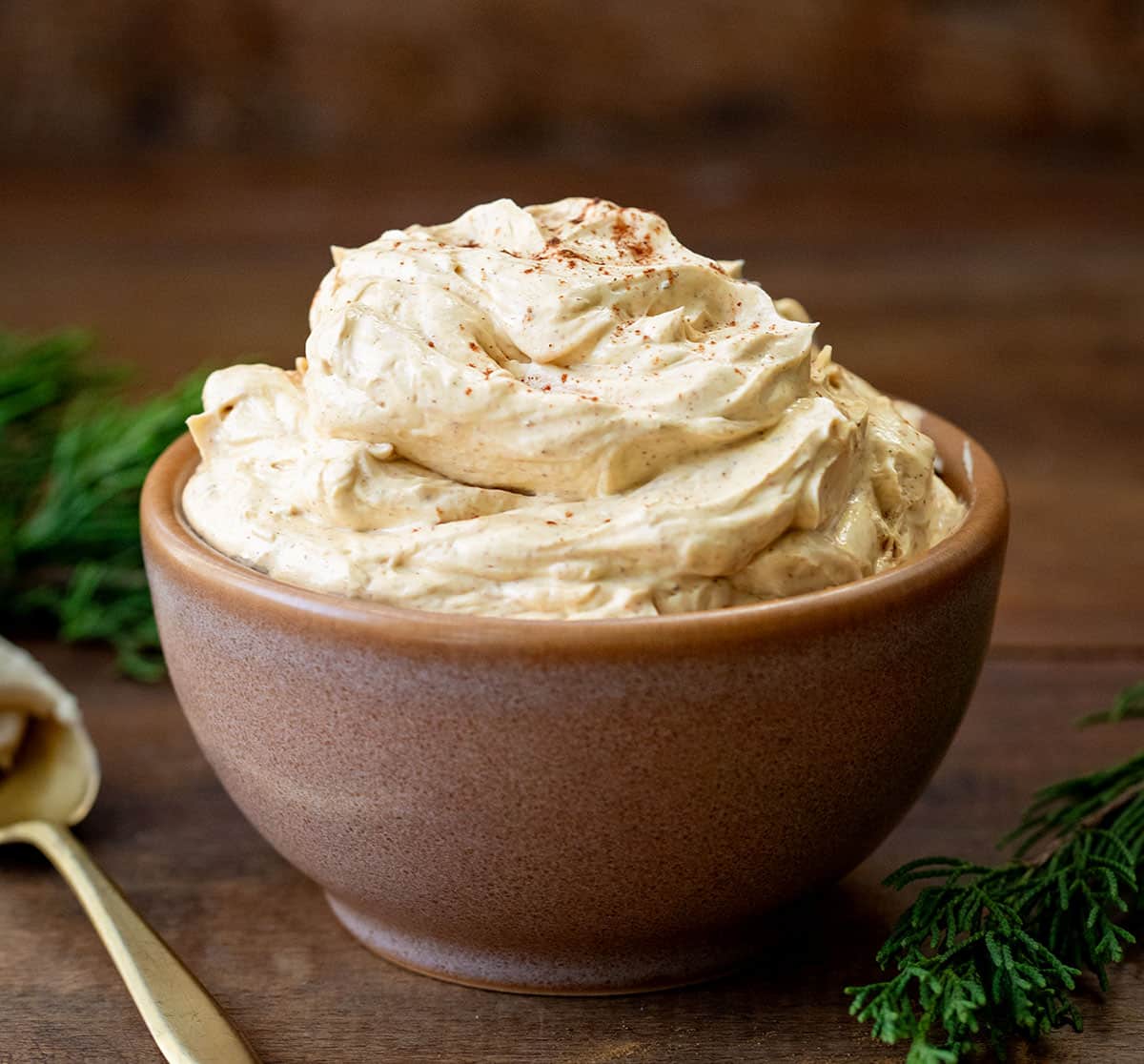 Bowl of Whipped Gingerbread Butter on a wooden table.