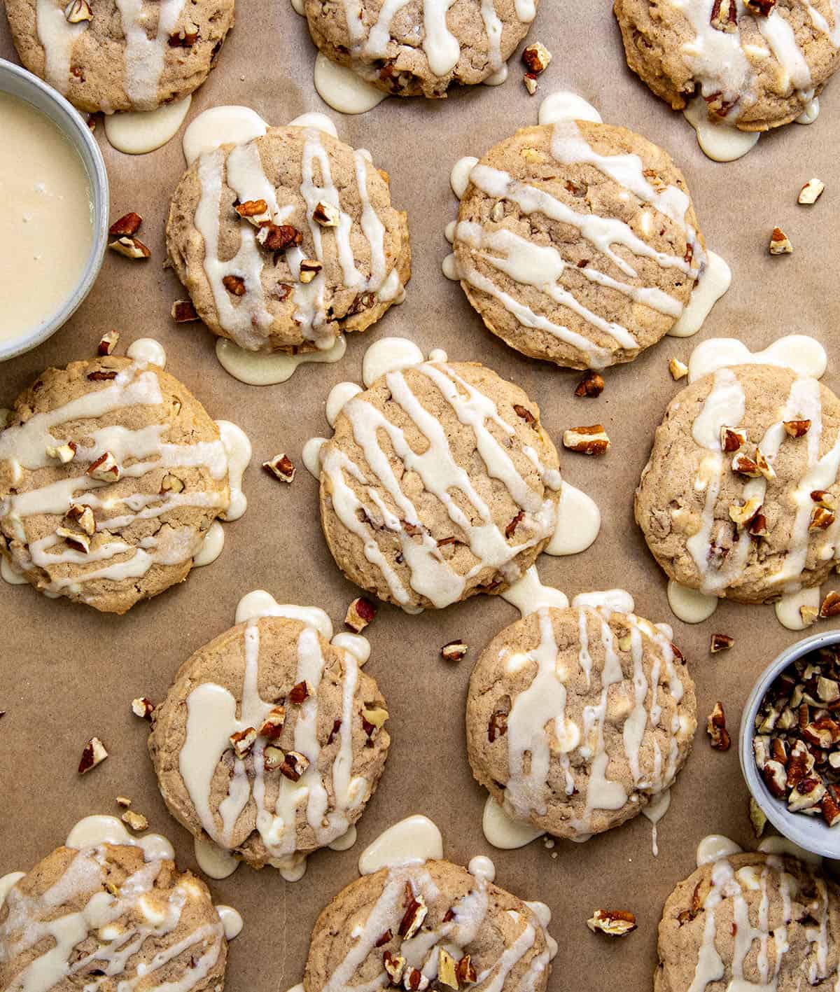 White Chocolate Maple Pecan Cookies laid out and covered in glaze from overhead.