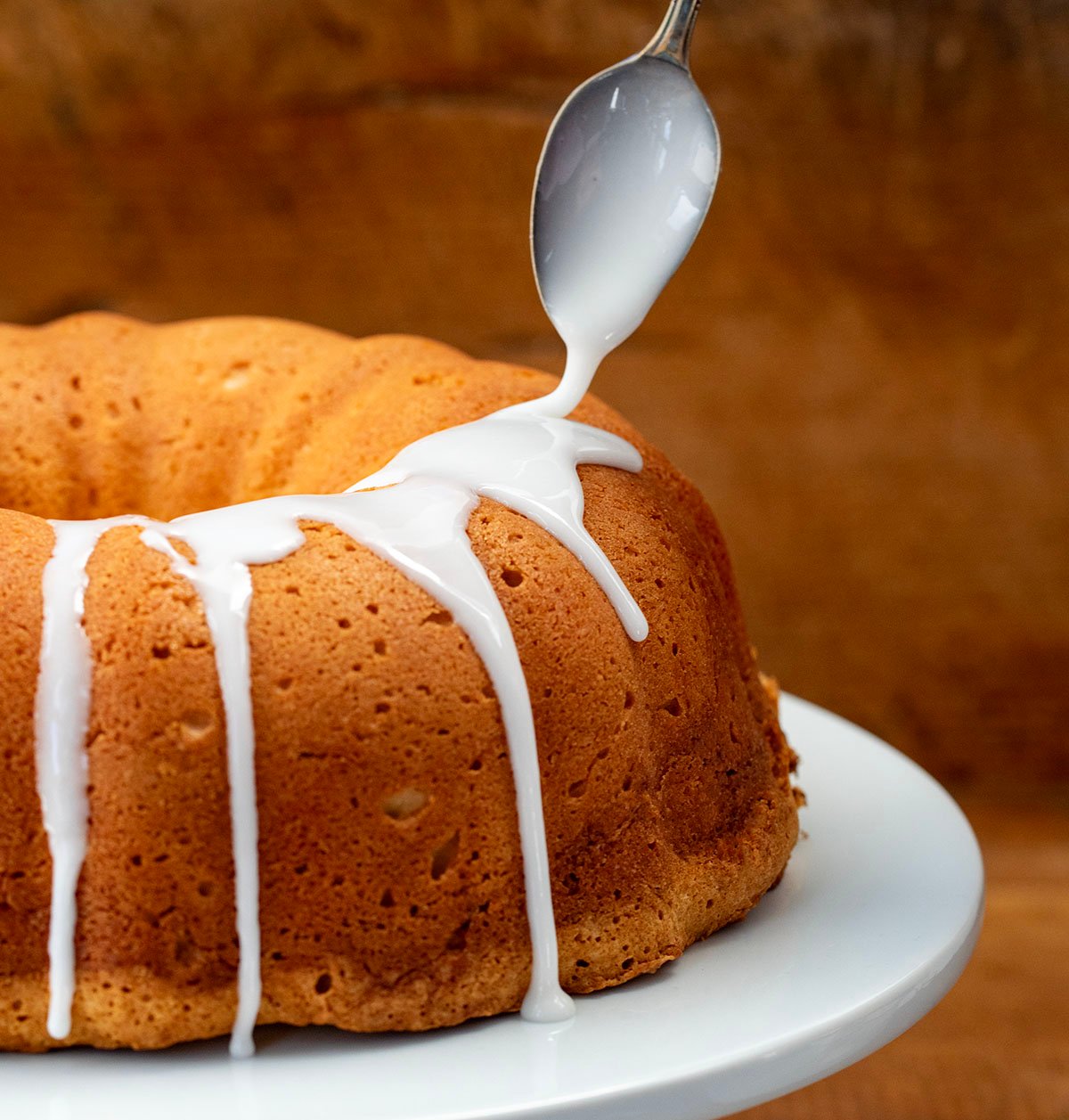 Drizzling Icing over a Cinnamon Swirl Bundt Cake.