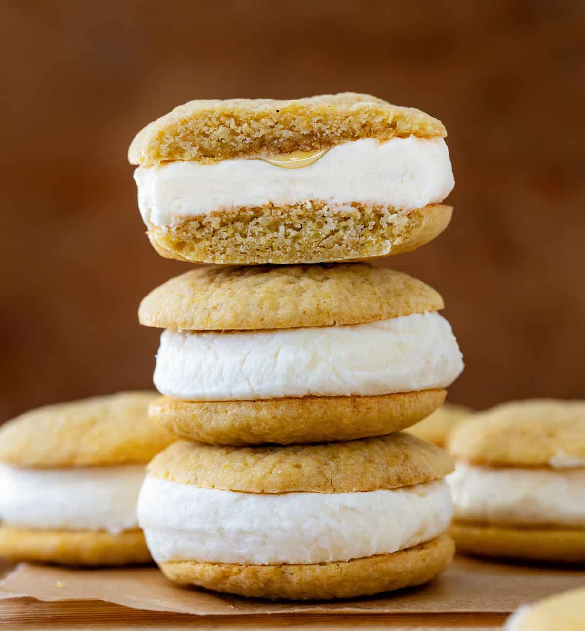 Stack of Cornbread Sandwich Cookies with the top cookie cut showing honey inside.